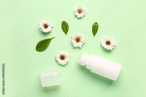 Deodorant with flowers and leaves on light green background
