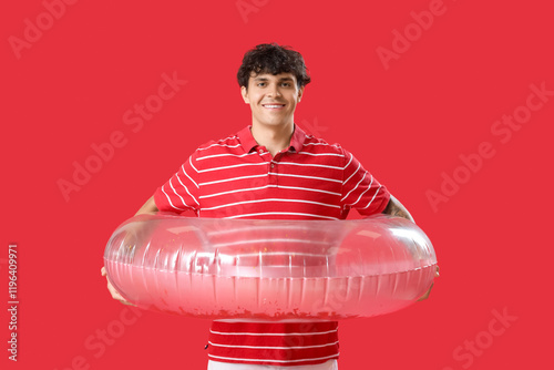 Young man with swim ring on...