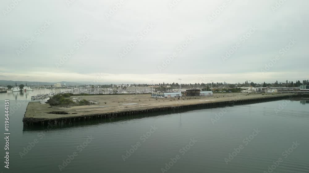 Encinal Basin drone view reveals the large pier with boats and yachts resting against the picturesque backdrop of Alameda's waterfront. Encinal Basin drone view reveals the large pier with boats and yachts resting against the picturesque backdrop of Alameda's waterfront.