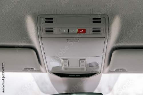 Overhead view of a car's interior console with lighting and SOS button photo