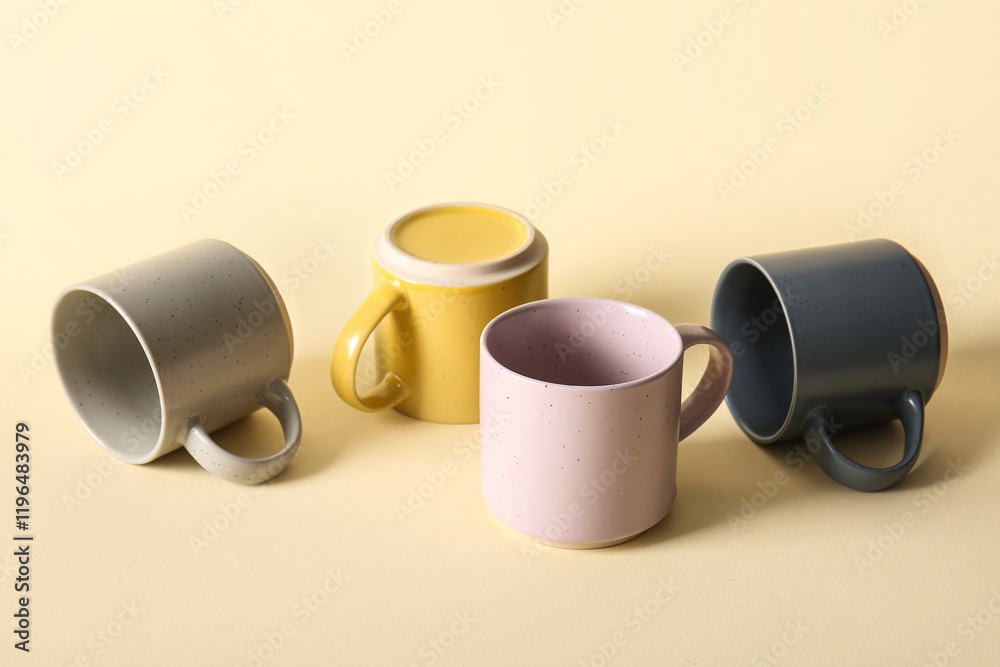 Set of different ceramic mugs on color background Set of different ceramic mugs on color background