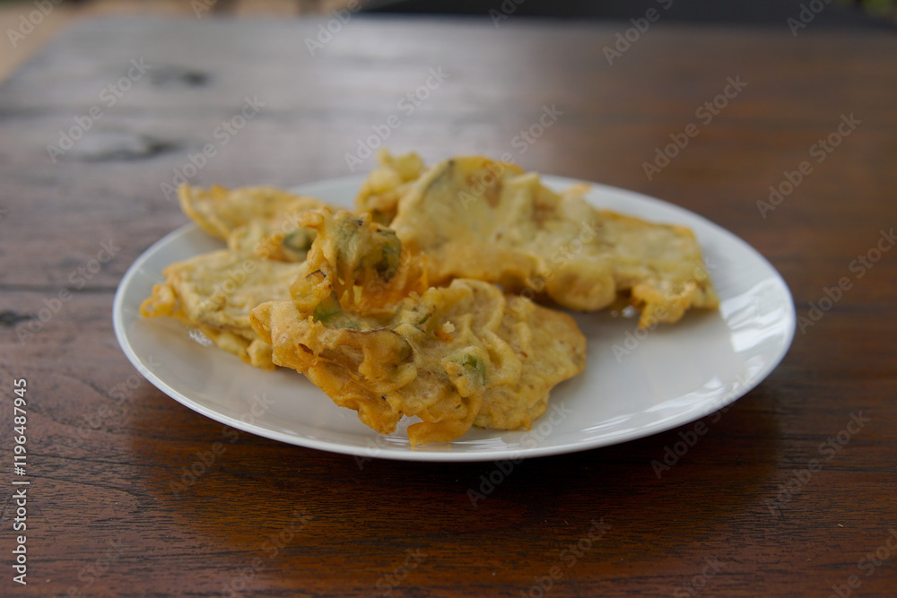 Mendoan Tempe with spicy sauce, Mendoan Tempe is a food made from Tempe fried with wheat flour Mendoan Tempe with spicy sauce, Mendoan Tempe is a food made from Tempe fried with wheat flour
