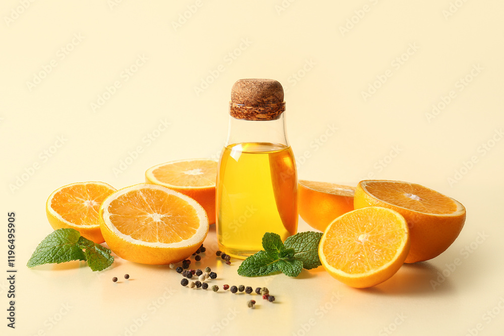 Bottle of orange essential oil with mint, peppercorns and fresh fruits on beige background Bottle of orange essential oil with mint, peppercorns and fresh fruits on beige background