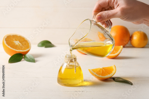 Hand pouring natural orange...