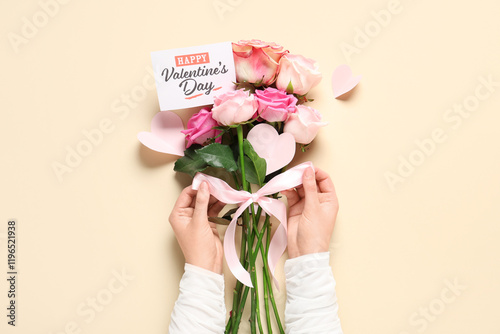 Young woman holding rose fl...