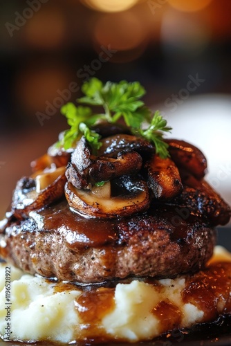 Burger with sautÃ©ed mushrooms and gravy served over creamy mashed potatoes, featuring gourmet dining atmosphere and delicious comfort food presentation. photo