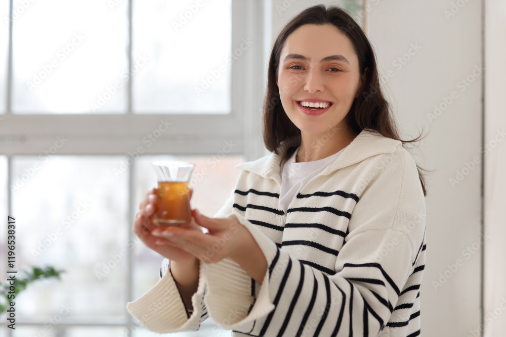 Young woman with glass of Turkish tea at home Young woman with glass of Turkish tea at home