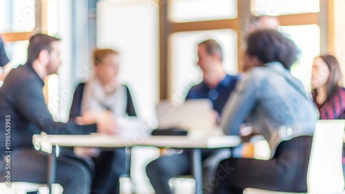 A team engaged in strategic discussions, with the meeting room background blurred for emphasis.	
 photo