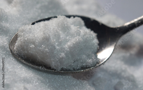 Closeup of taurine powder on spoon