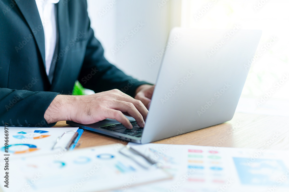 Man's hand typing on a laptop work space at home, or business evaluation concept, Financial analysis or business evaluation concept, Work space at home Man's hand typing on a laptop work space at home, or business evaluation concept, Financial analysis or business evaluation concept, Work space at home