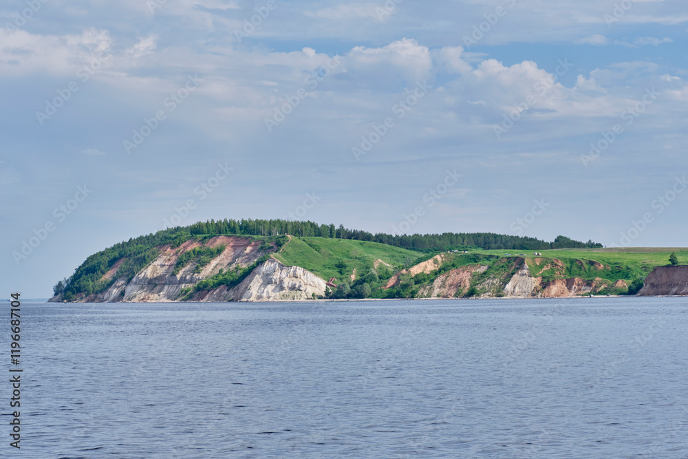Scenic coastal cliff with greenery and calm waters of river Volga, Russia Scenic coastal cliff with greenery and calm waters of river Volga, Russia