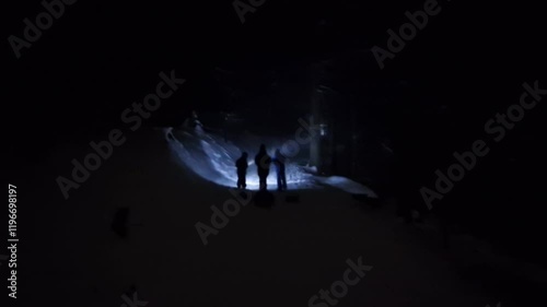 figures of people with flashlights shine on snowy road. equipped for survival in nature in winter. danger of searching for a hypothermic missing person in forest, team building, fear, owl, up photo