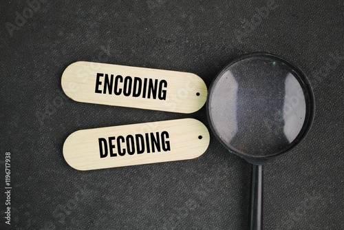 Slika na platnu magnifying glass and stick with the words encoding and decoding