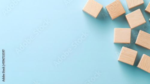 Wooden Blocks Displaying Skills Create a Beautiful Visual Arrangement on a Soft Blue Background, Evoking Creativity and Learning Spirit.