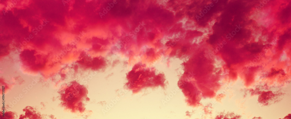 Red cloudy sky at sunset. Sky texture. Abstract nature background. Horizontal banner