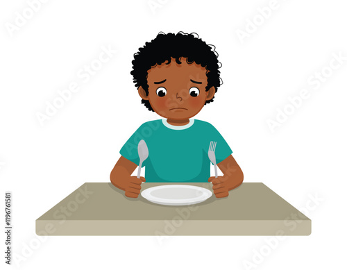 Sad little African boy feel hungry looking at empty plate
