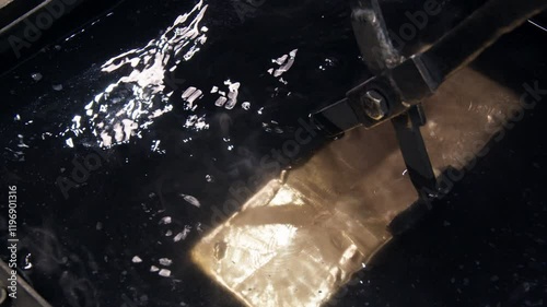 A captivating underwater image featuring a mysterious submerged object with reflections and shadows