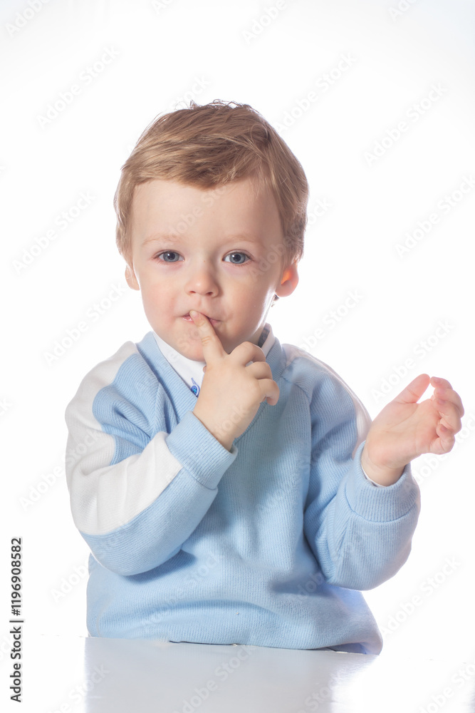 Emotional baby in shirt and blue jumper on white background