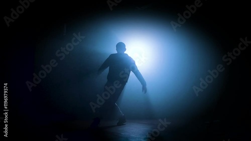 Silhouette of a man dancing break dance in a dark studio Dancer artist performing. High quality 4k footage