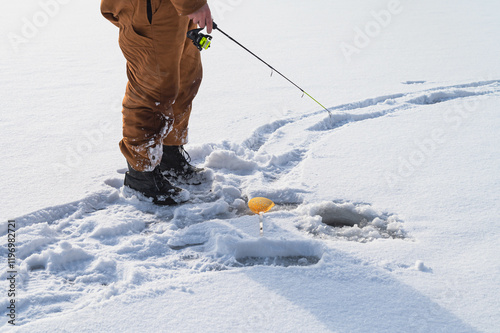 Ice fishing selective focus catching fish, winter activities background, man fishing on ice cadet isolated subject winter activities, overexposed white background photo