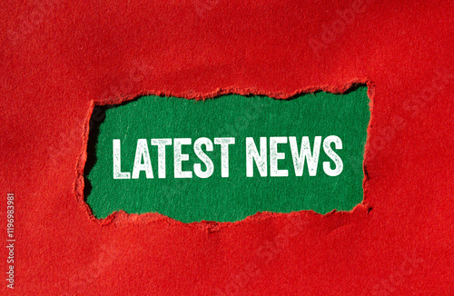 Latest news message written on ripped torn red paper on green background. Conceptual latest news symbol. Copy space. photo