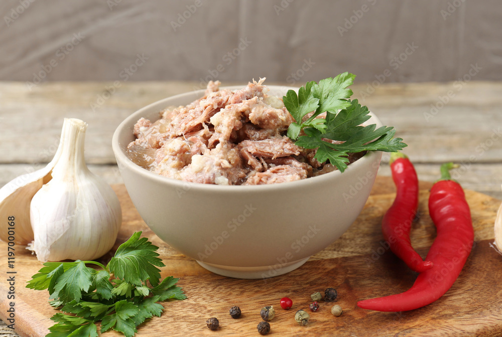 Canned meat in bowl and fresh products on table, closeup Canned meat in bowl and fresh products on table, closeup