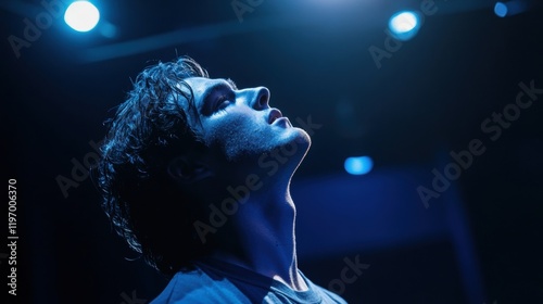 Intense Expression of a Young Man Under Dramatic Stage Lighting