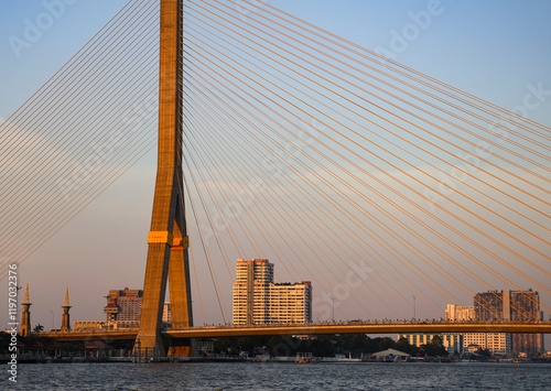 View of Rama VIII Bridge over Chaophraya River in the evening at sunset photo