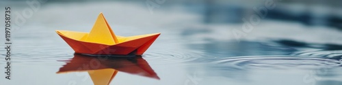 Brightly colored paper boat floats gently on serene water, refle photo