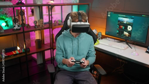 Young gamer plays game with friends online on the internet. Chats about the game. 
Wins tournament and is very happy. Happy young eSports player.