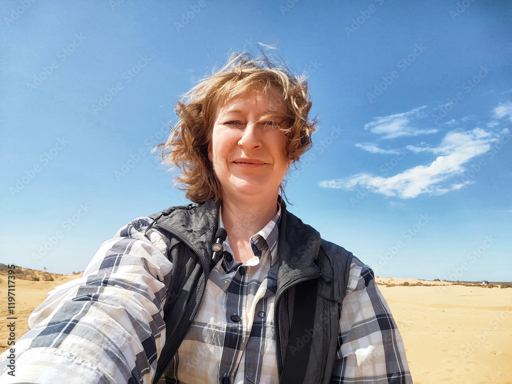 Adventures on a journey. A blogger poses, takes a selfie or podcast in the desert Adventures on a journey. A blogger poses, takes a selfie or podcast in the desert