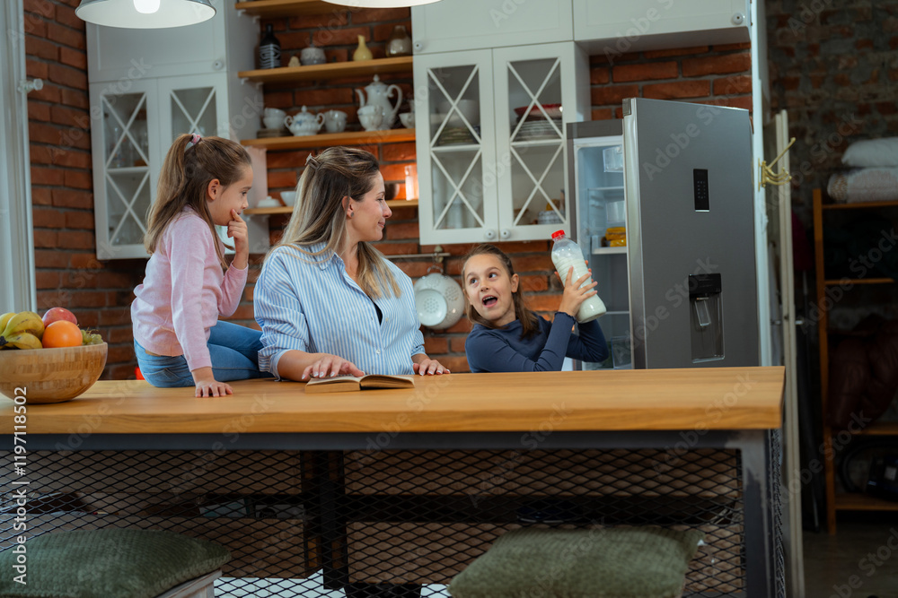 Two playful daughters and their smiling mother are spending quality time in their modern kitchen, with one girl excitedly retrieving a bottle of milk from the refrigerator Two playful daughters and their smiling mother are spending quality time in their modern kitchen, with one girl excitedly retrieving a bottle of milk from the refrigerator
