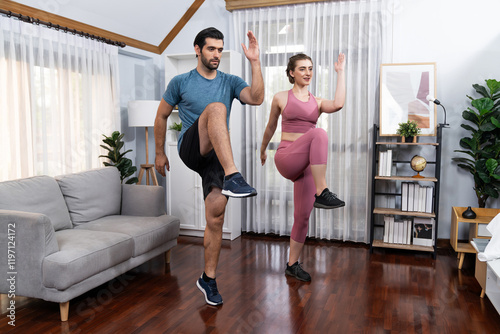 Athletic and sporty fitness couple or exercise buddy running posture at home body workout exercise session for fit physique and healthy sport lifestyle at home. Gaiety home exercise workout training.