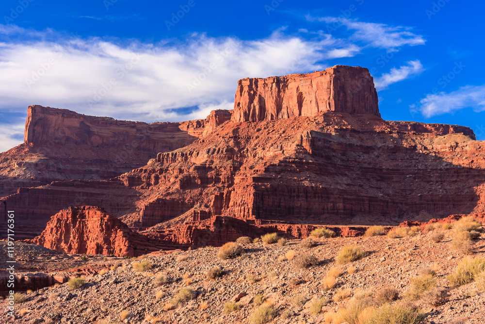 A mountain range with a cloudy sky in the background A mountain range with a cloudy sky in the background