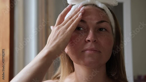 a woman applies a lifting serum or peeling to the skin of the face with a pipette, facial skin care