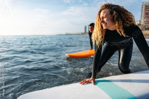 Photography Fit couple surfing at sunset