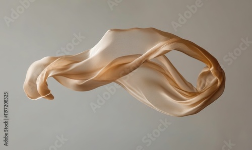 Sheer, flowing fabric suspends mid-air against gray background. photo