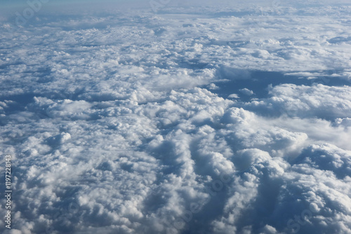 White cumulus fluffy clouds wallpaper taken from the plane in a blue sky good weather day