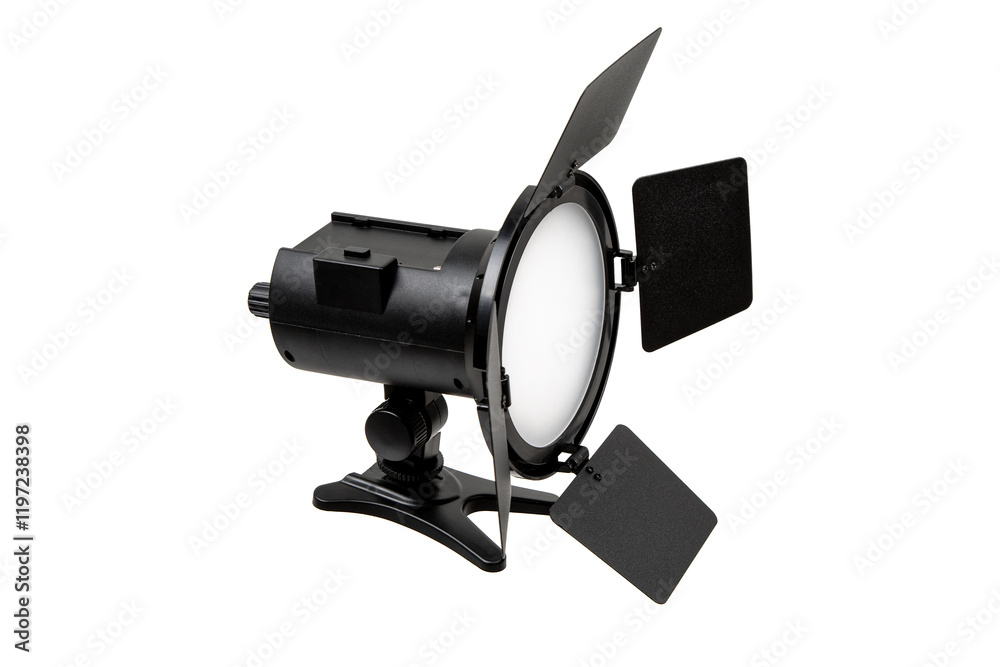 A professional studio light with barn doors, used for controlling light direction and intensity in photography and videography, mounted on an adjustable stand. A professional studio light with barn doors, used for controlling light direction and intensity in photography and videography, mounted on an adjustable stand.