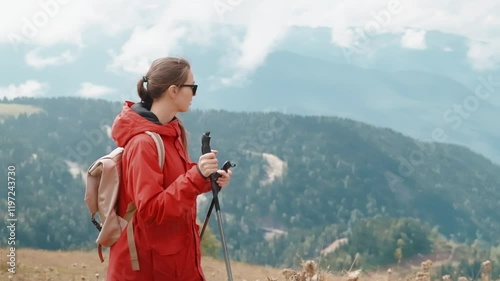 young woman travelling alone in mountains, walking on top and viewing beautiful landscape, portrait