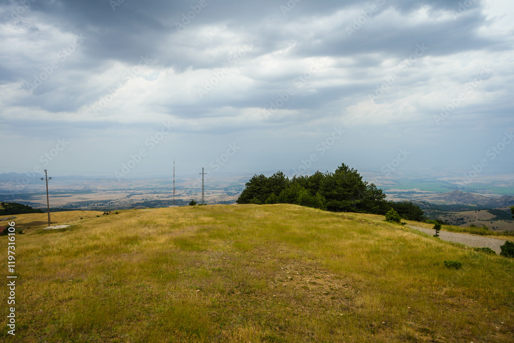 Fototapeta premium View from mountains across valley to south east with city of Stip on center horizon. Stip, Macedonia 