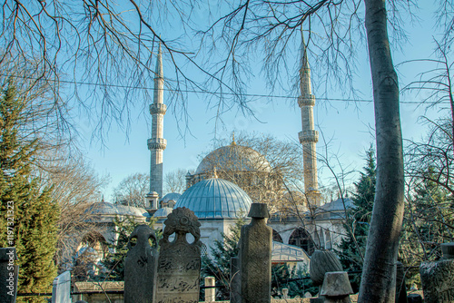 View of  historical tombstones and Eyup sultan mosque (cami) in the eyup town istanbul  photo