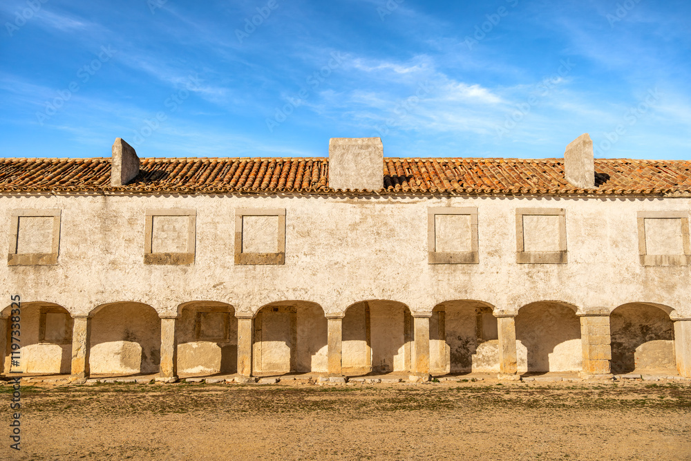Fototapeta premium Colonnade Building at Santuário de Nossa Senhora do Cabo Espichel on a Sunny Day, Portugal. December 2024