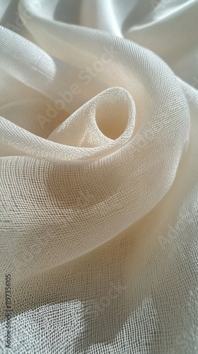Soft white fabric gracefully draped, highlighting delicate texture and subtle...