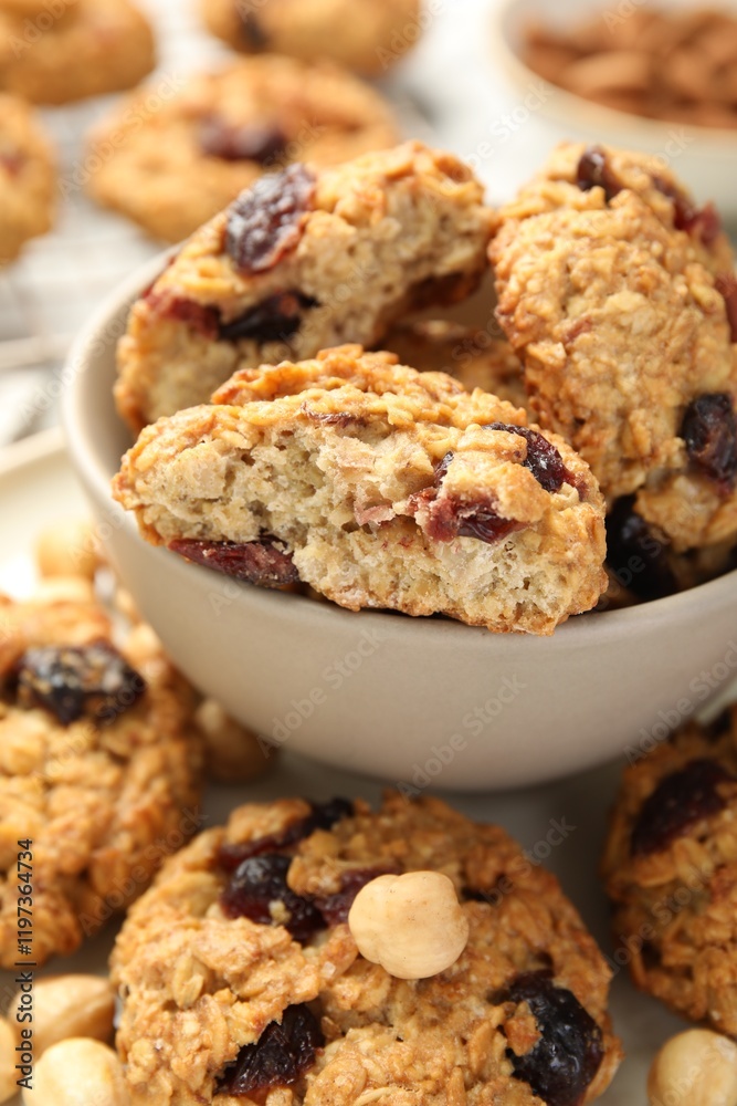 Delicious oatmeal cookies with raisins and nuts on table, closeup Delicious oatmeal cookies with raisins and nuts on table, closeup