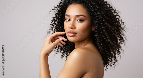Beautiful Woman with Curly Hair Smooth Skin and Natural Makeup
