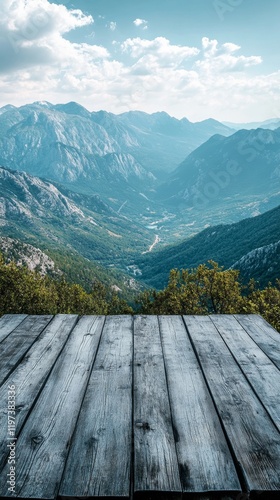 Scenic view from a wooden deck overlooking a tranquil lake surrounded by maje...