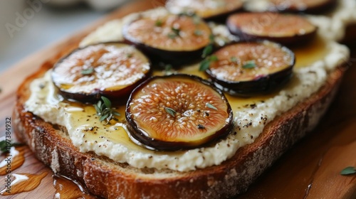 Delightful breakfast featuring fresh figs, creamy cheese, and honey on toaste...