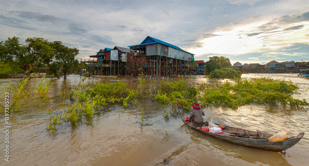Naklejka premium Tonle Sap lake, Siem reap Province, Cambodia. Fisherman in his boat, Floating village of Kompong Phluk, Cambodia.