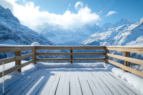 Snowy mountain view from a wooden observation deck in a winter landscape with...